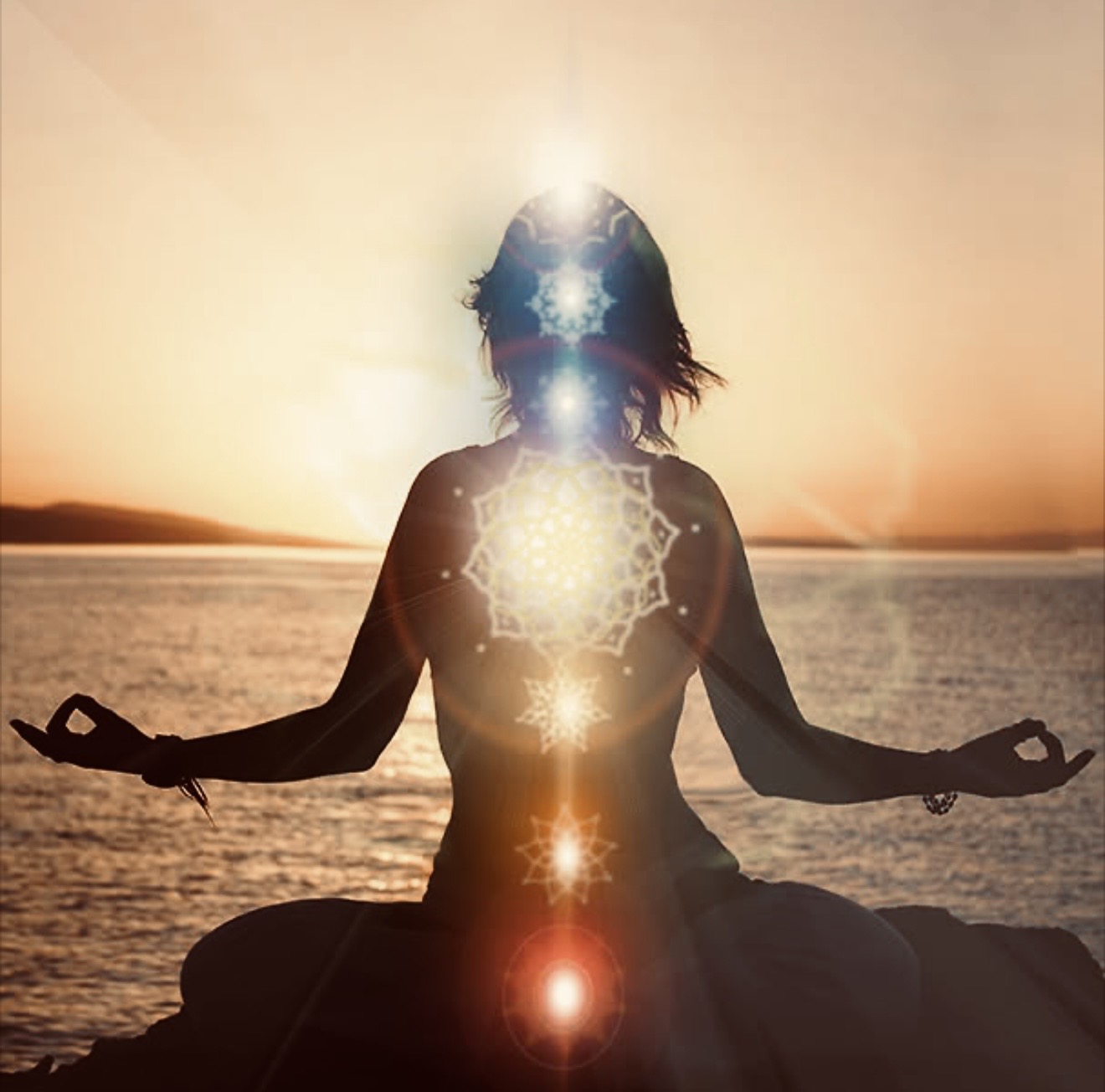 A seated meditation silhouette faces sunlit water, with seven glowing chakra symbols rising through the body.